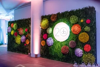 What are some tips for maintaining a flower backdrop throughout an event?