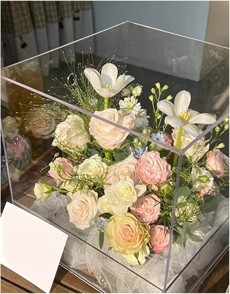 Clear storage container filled with artificial flowers for seasonal organization