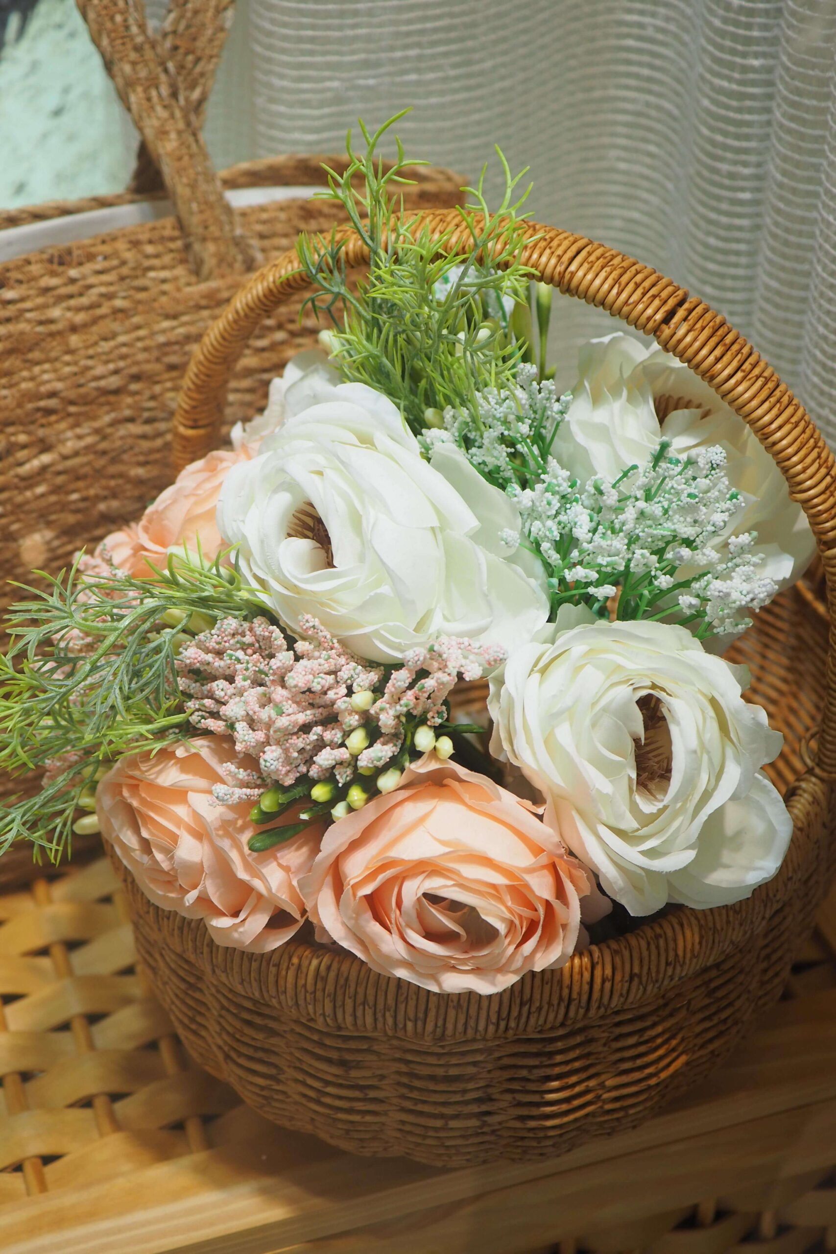Wicker basket filled with artificial flowers for rustic decor