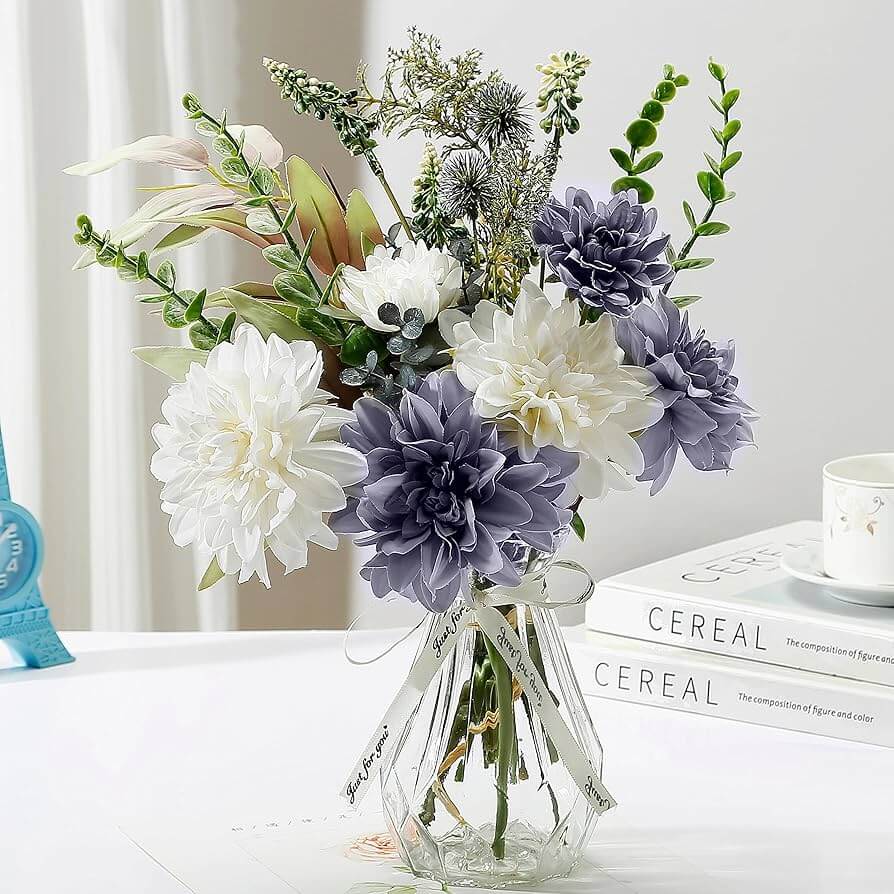Artificial flowers arranged in modern glass vase for home decor