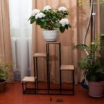 Artificial flower storage ideas using clear containers and tiered display shelves