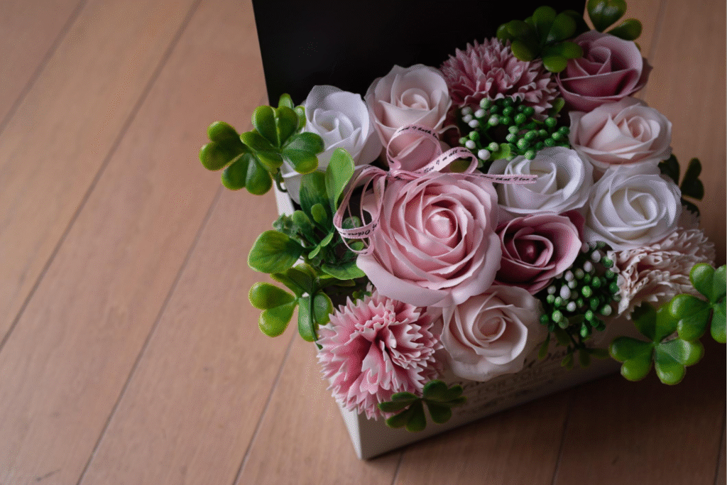 Luxury artificial rose arrangement with pink and white blooms in decorative box
