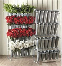 Vertical metal rack displaying artificial flowers in tiered cone-style containers